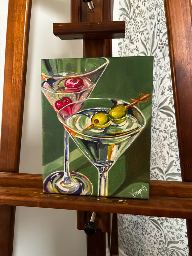 Oil painting of two martini glasses on a green background — one holding cherries, the other olives on a pick.